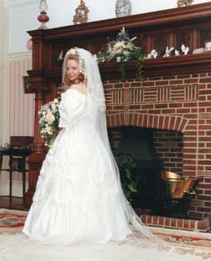 One of the Dunn daughters on her wedding day in front of the famous fireplace with inscription